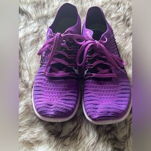 Purple Nike running shoes… signs of typical wear…
